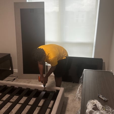 Pantheon Moving crew member wrapping and protecting furniture for a Kansas City move